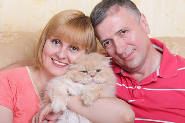 A cute family enjoying their life with a fluffy big cat