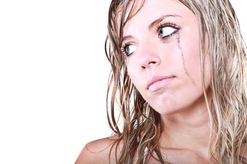 A young depressed blond woman with a tear running down