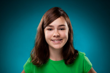 Portrait of young girl on blue background