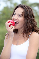 Closeup of woman eating a red apple