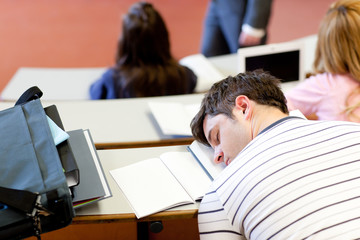 Asleep male student during an university lesson