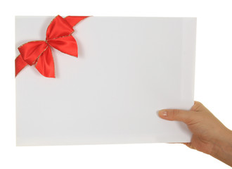 Paper card with red ribbon in woman hand