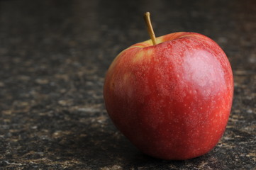 Red Apple on Black Kitchen Countertop