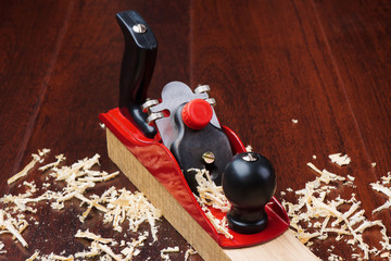 Red plane on brick and shavings