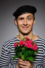 Funny emotional romantic sailor man holding rose flowers prepare