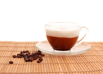 cup of coffee and beans on bamboo mat