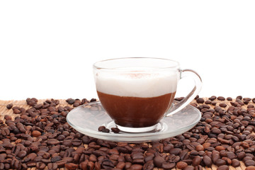 cup of coffee and beans on bamboo mat