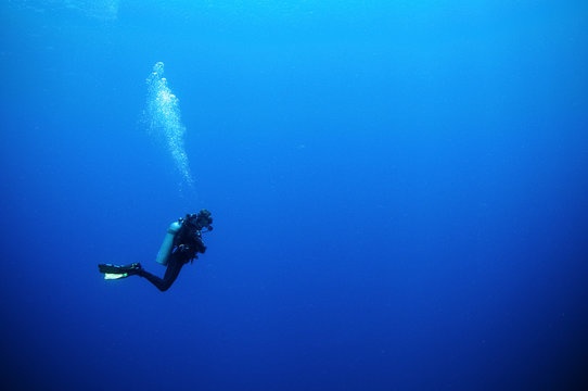 scuba diver in deep blue water