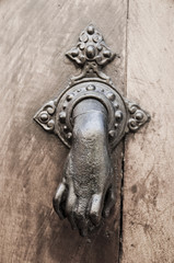Hand Doorknocker on allwood door.