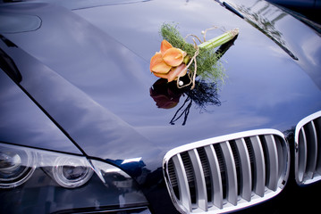 Wedding car with bridal bouquet
