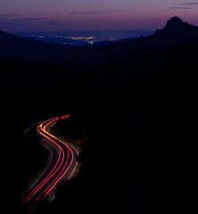car moving fast on a winding road  at dusk