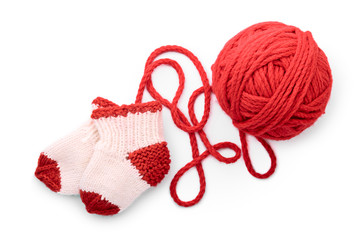 Isolated red skein and knitted socks