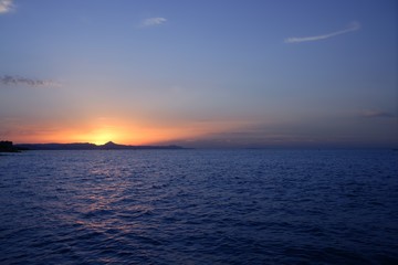 Beautiful sunset sunrise over blue sea ocean red sun sky