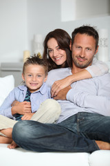Obraz premium Closeup of parents and child relaxing at home on sofa