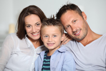Fototapeta premium Closeup of parents and child relaxing at home on sofa