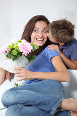 Little boy kissing his mom on mother's day