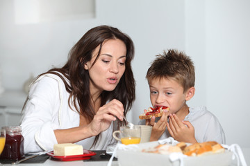 Obraz na płótnie Canvas Mother and son having breakfast