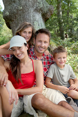 Family sitting in nature on a hiking day