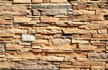 Part of a wall built of bricks of different natural