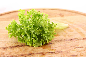 Green salad leaves on wooden surface