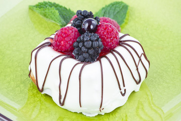 Black and White chocolate with blackberries on green plate