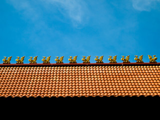 Thai temple's roof with the wooden sculptures of myth bird