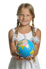 The girl holds the globe collected from puzzle in hands. Selecti