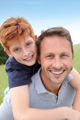 Obraz premium Closeup of father and son in countryside