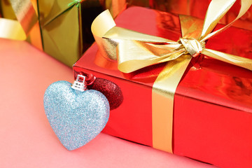 Several multi-colored gift boxes and decorative heart