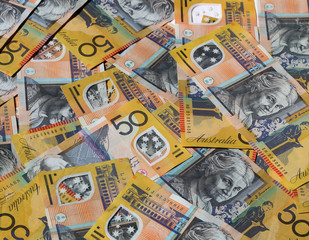 Closeup of many Australian 50 dollar notes.