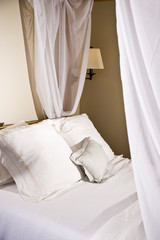 Pillows on a white canopy bed