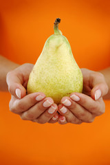 pear in woman hands
