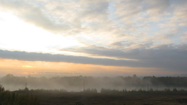 rural mist landscape with sunrise over lake