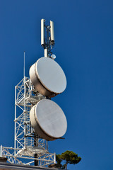 Telecommunication mast with microwave links antennas.