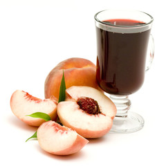 glass of fruit juice and peaches isolated on white
