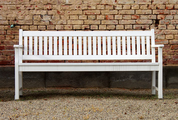 white bench brick wall