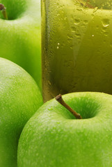 Glass with juice on a background of apples