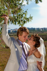 Newlyweds relax in the park.