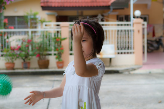 little girl playing with ball