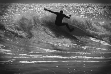 Surfer on a wave in black and white