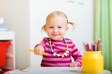 Playful little girl drawing