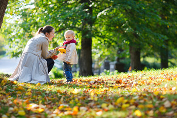 Mother and daughter at autumn park