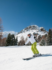 Fototapeta na wymiar Woman skiing downhill