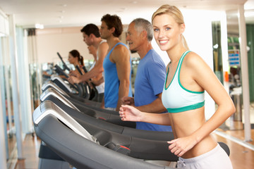 Fototapeta premium Woman On Running Machine In Gym