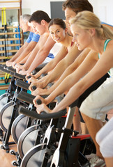 Woman Cycling In Spinning Class In Gym