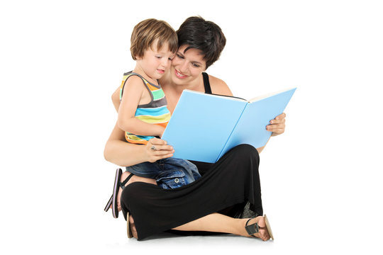 Smiling mother and boy reading a book together