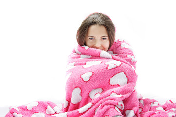 studio shot of yuong attractive woman wrapped in pink blanket