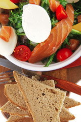 salad with salmon on bread with tomatoes
