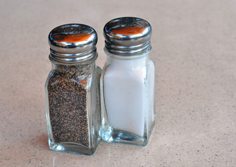 A salt and pepper shakers on a marble table