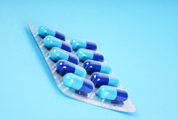 Medical tablets isolated on blue background